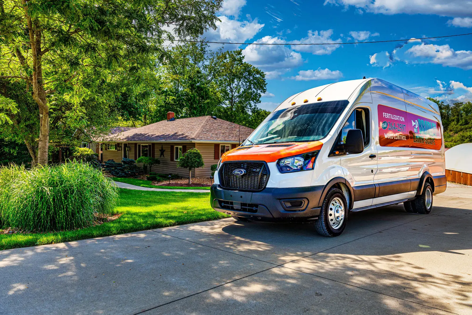 Bradley Lawn-Scape van parked in the driveway of a home with a green lawn